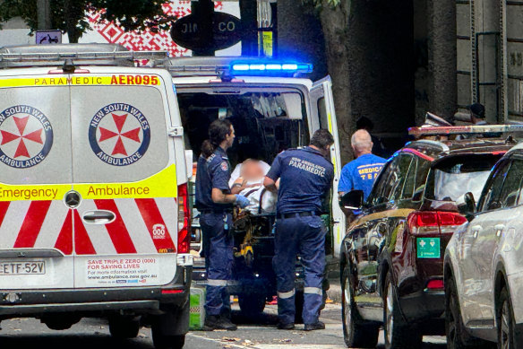 Paramedics treat Van Cooney after a shooting on Castlereagh Street in Sydney’s CBD.