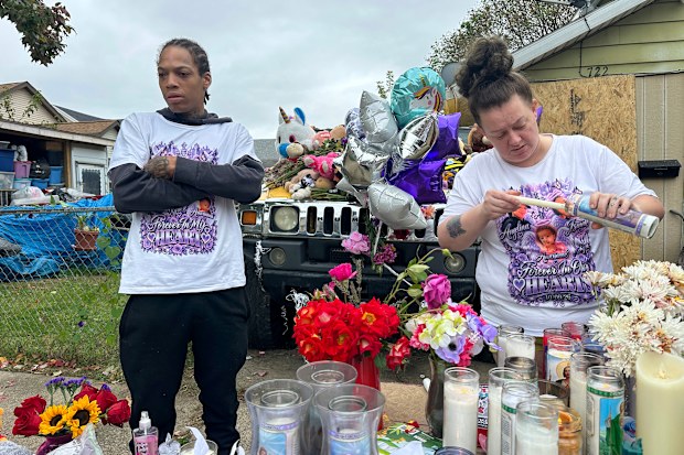 Julius Windham visits a memorial outside the home where authorities say a gunman killed multiple people, including his daughter.