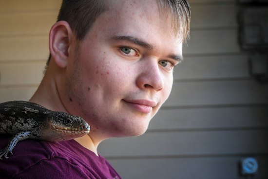 Flynn Spencer with his pet blue tongue lizard.