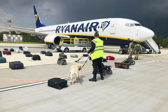 Belarusian security checks luggage on the grounded Ryanair flight in Minsk on Sunday.