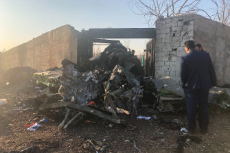 Debris is seen from a plane crash on the outskirts of Tehran, Iran, carrying at least 170 people.