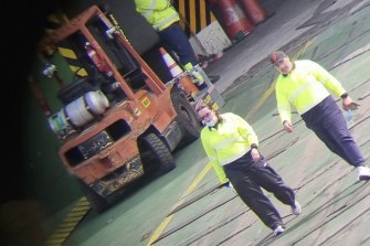 Qube workers at Fremantle Port on Sunday. 