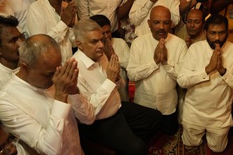 Sri Lanka’s new prime minister Ranil Wickremesinghe, second left, said he was forced to print money to pay salaries. 
