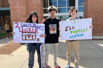 Pirates of the Caribbean fans Hannah Yeahgley, Ethan Diddlemeyre and Nick Lusby outside Depp's defamation trial with signs they made in support of the actor.