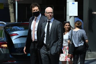 Chris Hanger (centre), deputy secretary in the Department of Regional NSW, outside the ICAC. Mr Hanger is not accused of wrongdoing.