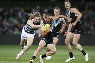 Travis Boak is chased by Tom Guthrie on Thursday night.