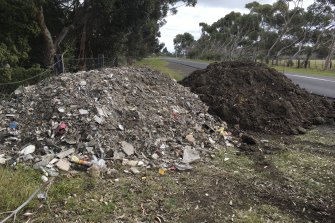 Two piles of contaminated soil on a roadside in Melbourne’s north-west last month.