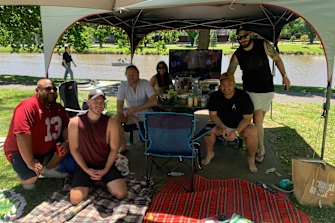 Neale Philippe and his mates enjoy the atmosphere at their Melbourne Cup day picnic.