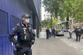 A police officer from the public order response team outside the offices of Novak Djokovic’s lawyers in Melbourne’s CBD on Saturday.