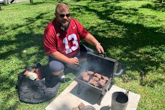 Neale Philippe works the grill at his Melbourne Cup Day picnic with mates.