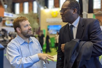 US pollster Frank Luntz speaks to British cabinet minister Kwasi Kwarteng at the Conservative Party conference in Manchester.