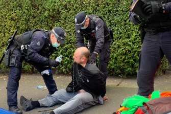 A man has water poured on his eyes after police and protesters clashed on Saturday.