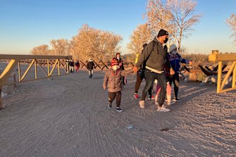 Migrants walk to an area in Yuma, Arizona, where they surrender to Border Patrol, hoping to seek asylum in the United States.