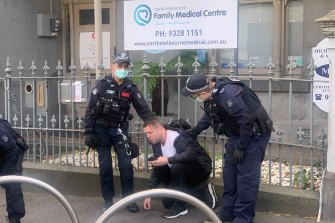 A bleeding man is treated after violence between a small group of protesters and police.