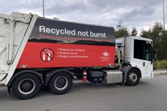 A garbage truck emblazoned with an anti-incinerator message.