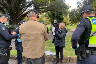 Victoria Police attend an anti-lockdown protest on Saturday.