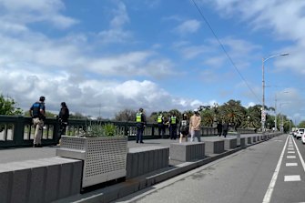 A number of uniform and plain clothes police officers have corralled on Princes Bridge near Flinders Street Station.