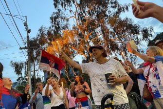 Novak Djokovic supporters light candles and sing in Serbian outside the Park Hotel in Melbourne.