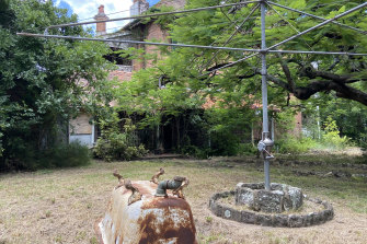 An upturned bath lies abandoned beneath the Hills Hoist in the backyard of “Home”, known colloquially as Lamb House.
