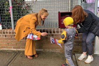 Emily Park, right, at Willoughby Public School with her son, Milo, speaking to Labor’s Catherine Renshaw.