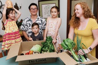 Bridget Choi, her husband Ray and their children (L-R) Norah, Remy and Hazel with their weekly Your Food Collective grocery delivery at home in Sydney’s Lane Cove.