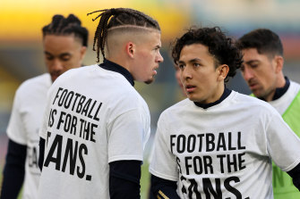 Kalvin Phillips of Leeds United warms up for the Liverpool clash while wearing a protest T-shirt.