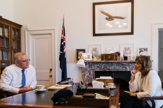 Morrison in his office with senior writer Deborah Snow and the  eagle image, a divine signal, he says, he needed to persevere.