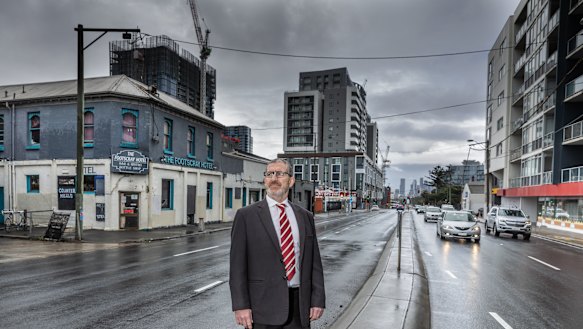Footscray real estate agent Tony Gerace near some of Footscray’s apartment towers, many of which have empty apartments.