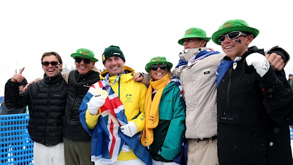Cooper Woods celebrates with supporters after winning gold in the freestyle skiing moguls.