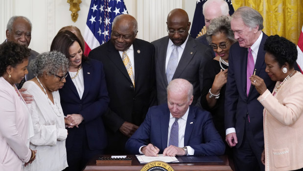 President Joe Biden signs the bill in the East Room of the White House.