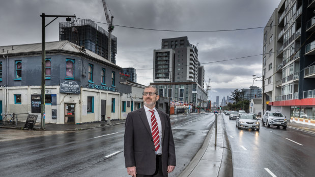 Footscray real estate agent Tony Gerace near some of Footscray’s apartment towers, many of which have empty apartments.