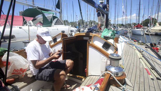 Last-minute repairs: Michael Spies, foreground, and Matt Stafford aboard Mark Twain. 