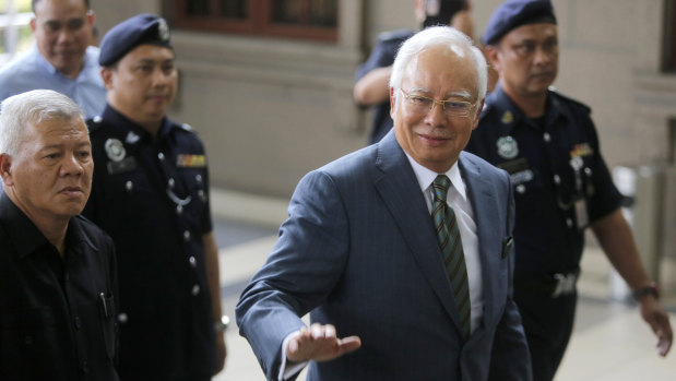 Former Malaysian prime minister Najib Razak, right, arrives at the High Court of Malaya in Kuala Lumpur on Wednesday.