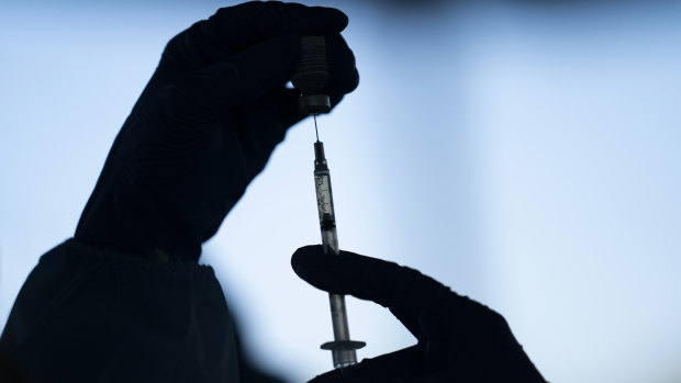 A medical staff member prepares the Pfizer-BioNTech COVID-19 vaccine in California.