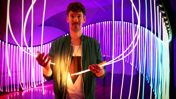 Australian artist Flynn Talbot with his rainbow flag-inspired work at the London Design Biennale. 