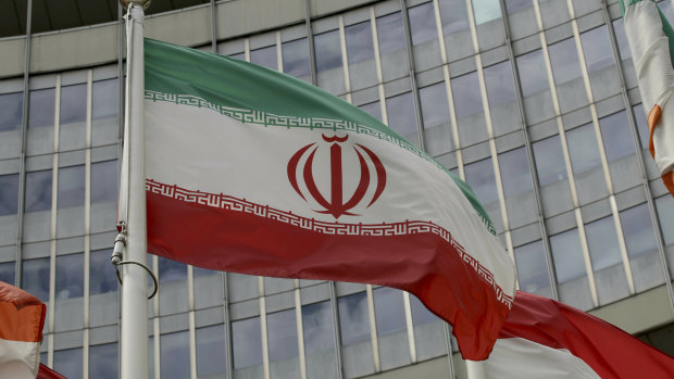 The Iranian flag waves outside of the UN building that hosts the International Atomic Energy Agency office in Vienna.