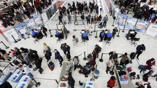 Travellers line up for a security checkpoint at John F. Kennedy International Airport.