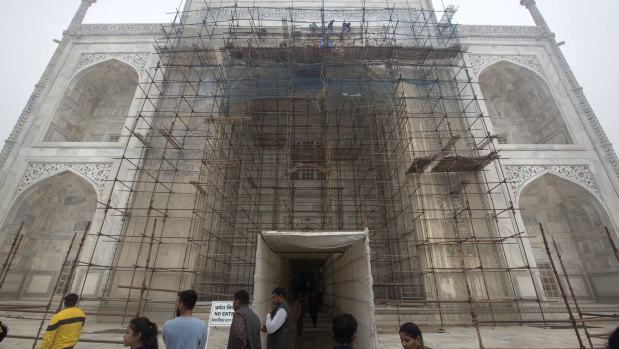Indian workers clean discolouration on the Taj Mahal in December.