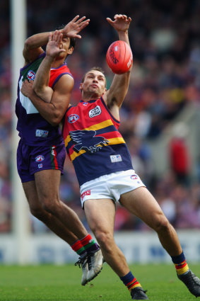 Tyson Edwards of the Crows and Jeff Farmer of the Dockers competes for the ball.