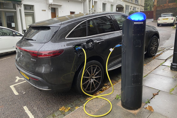 An electric vehicle charges at a public fast-charging station in London. The UK and EU will ban petrol cars in 2035. 