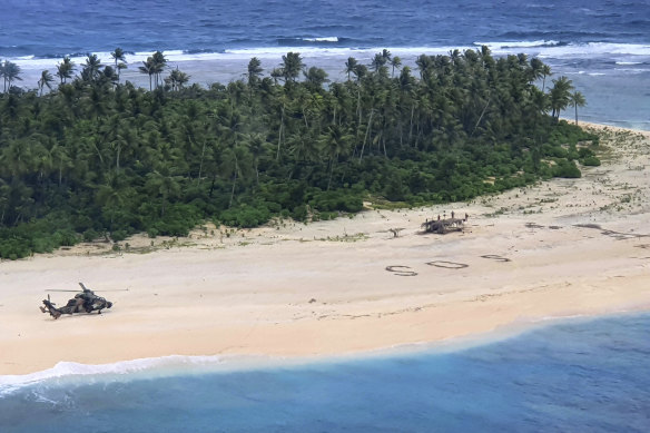 An Australian Army helicopter lands on Pikelot Island in the Federated States of Micronesia, where three men were found on Sunday after missing for three days.