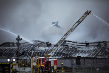 Up to 60 firefighters are battling a huge factory fire in Melbourne's north, which is sending plumes of smoke into surrounding communities.