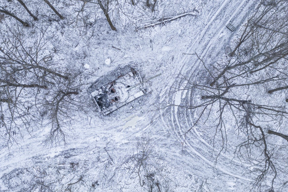 A wrecked Russian tank covered by snow stands in a forest in Kharkiv region, Ukraine,