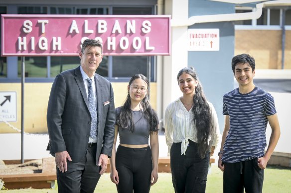 St Albans Secondary College stars Kelly Lam (dux), Maybel Verma and Deniz Daymen with principal Craig Jennings.