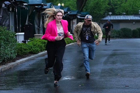 Members of the media clear the North Lawn following reports of gunfire near the White House in Washington DC on May 23 (US time).