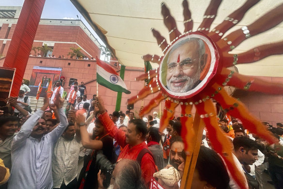 Bharatiya Janata Party (BJP) supporters dance inside the party office on Tuesday.