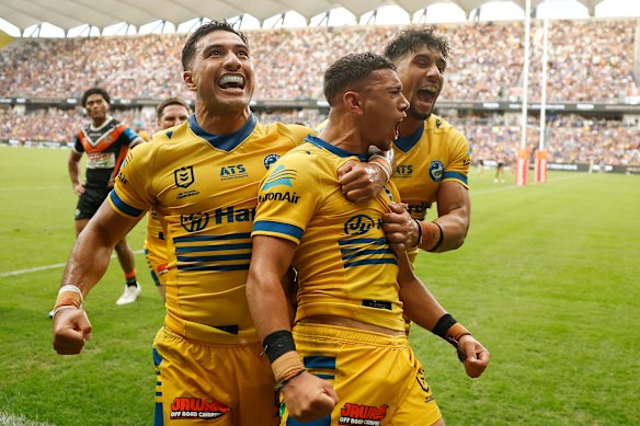 Isaiah Iongi celebrates with teammates after scoring a try for the Eels on Monday.