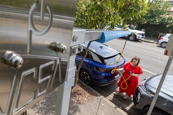 Melissa Rogerson in Brunswick East is part of a council trial for a boom to safely suspend EV charging cables above the footpath.