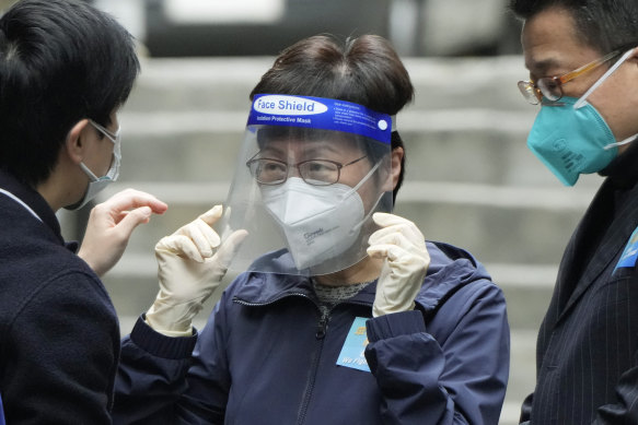 Hong Kong Chief Executive Carrie Lam, centre, has asked all residents to test themselves for COVID-19.