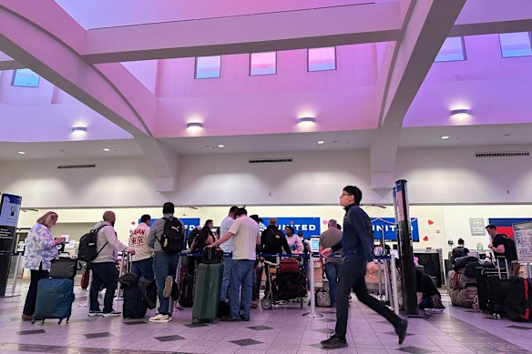 People stand in line at check-in counters at El Paso International Airport on Wednesday.